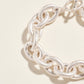Silver chain bracelet on a beige background