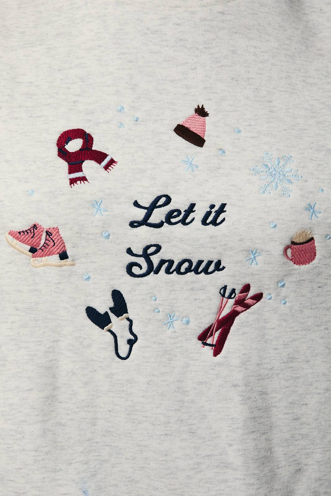 Gray sweatshirt with winter-themed embroidery including a dog, scarf, boots, and 'Let it Snow' text.