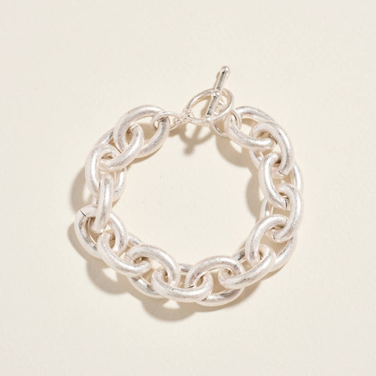 Silver chain bracelet on a light beige background