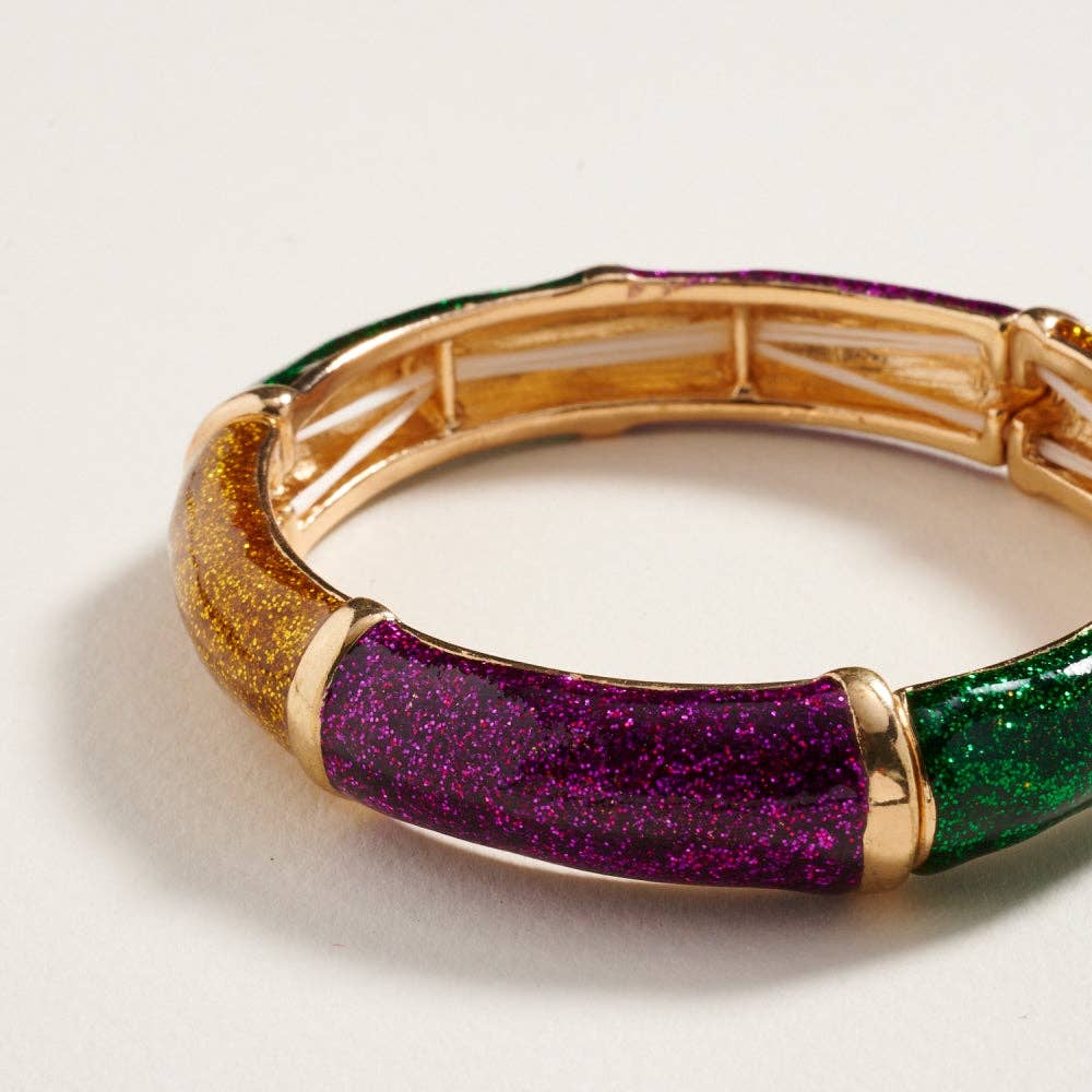 Multicolored bracelet with gold accents on a light background