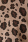 Close-up of a fabric with a leopard print pattern on a beige background