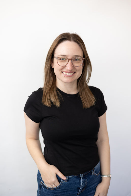 Person wearing a black t-shirt and blue jeans against a white background