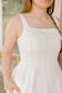 Woman wearing a white dress with a blurred background