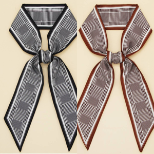 Two plaid scarves with bows on a beige background