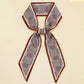 Plaid scarf with brown border on a beige background