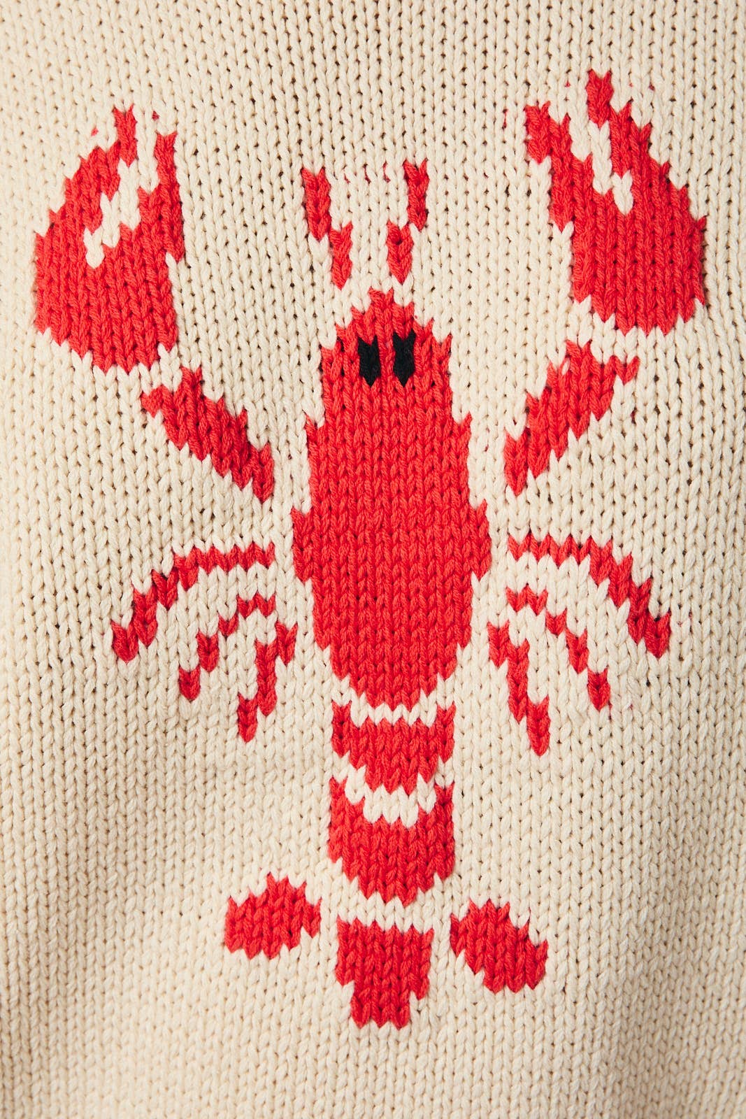 Red lobster design on a beige knitted fabric