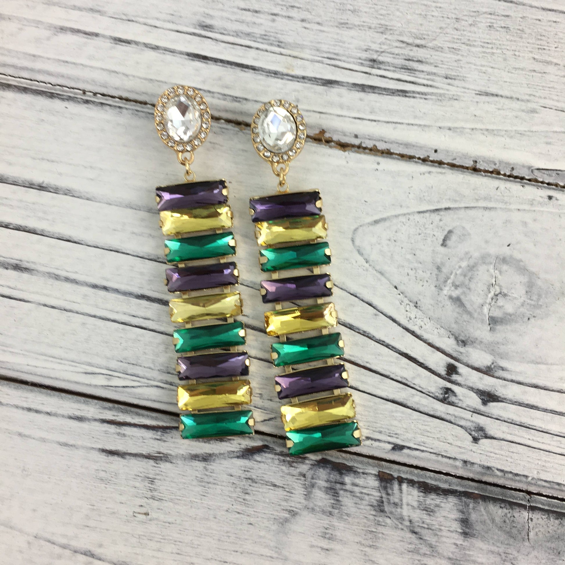 Colorful gemstone earrings on a wooden surface