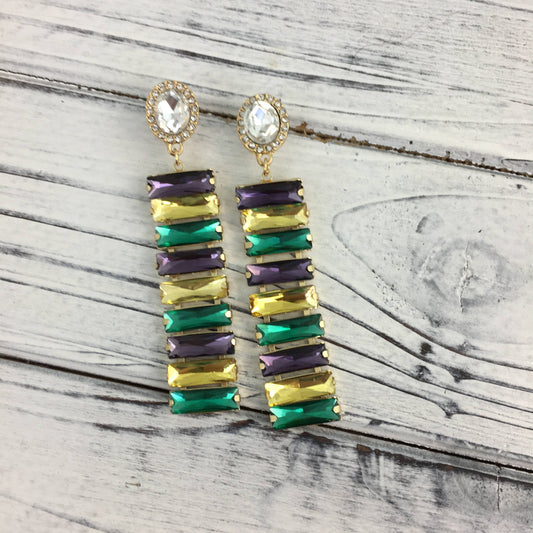 Colorful gemstone earrings on a wooden surface