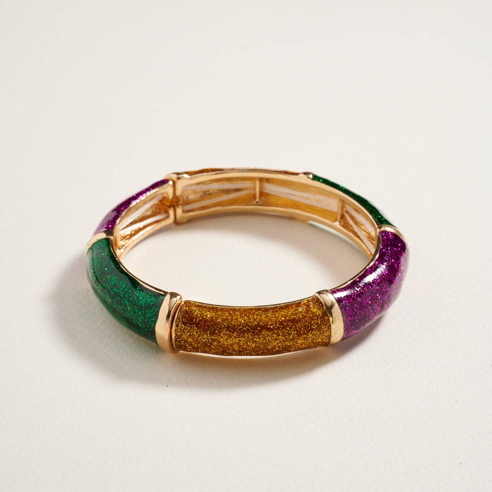 Multicolored bracelet with gold accents on a light gray background