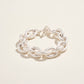 Silver chain bracelet on a light beige background